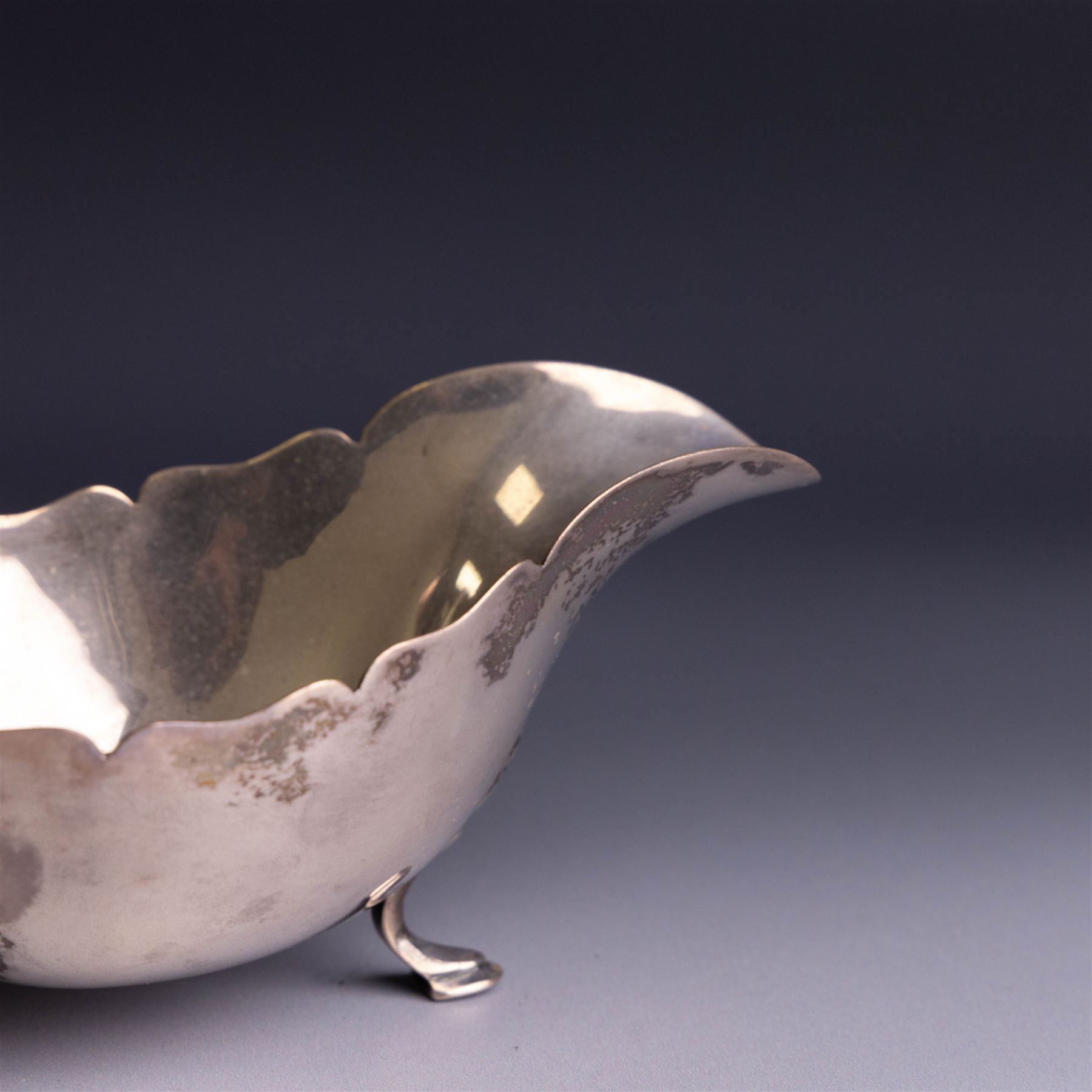 1930s silver sauceboat, of typical form with shaped rim and flying C scroll handle, upon three stepped feet, hallmarked Collingwood & Sons Ltd, Sheffield 1938