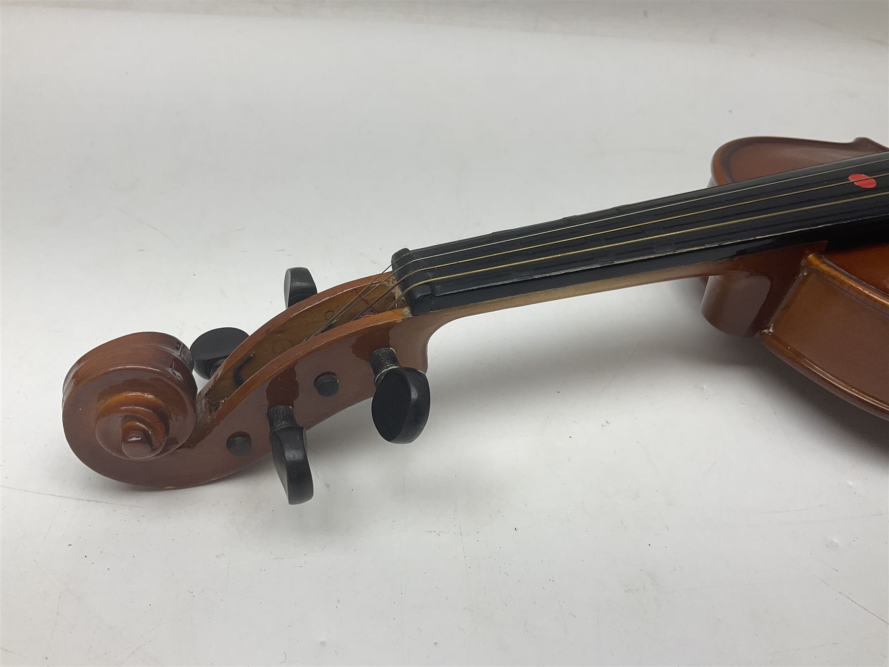 Four Chinese graduated violins - full size with 35.5cm two-piece back; three-quarter size with 33.5cm two-piece back; half size with 31cm two-piece back; and quarter size with 27.5cm two-piece back; all cased except full size; one with bow (4)