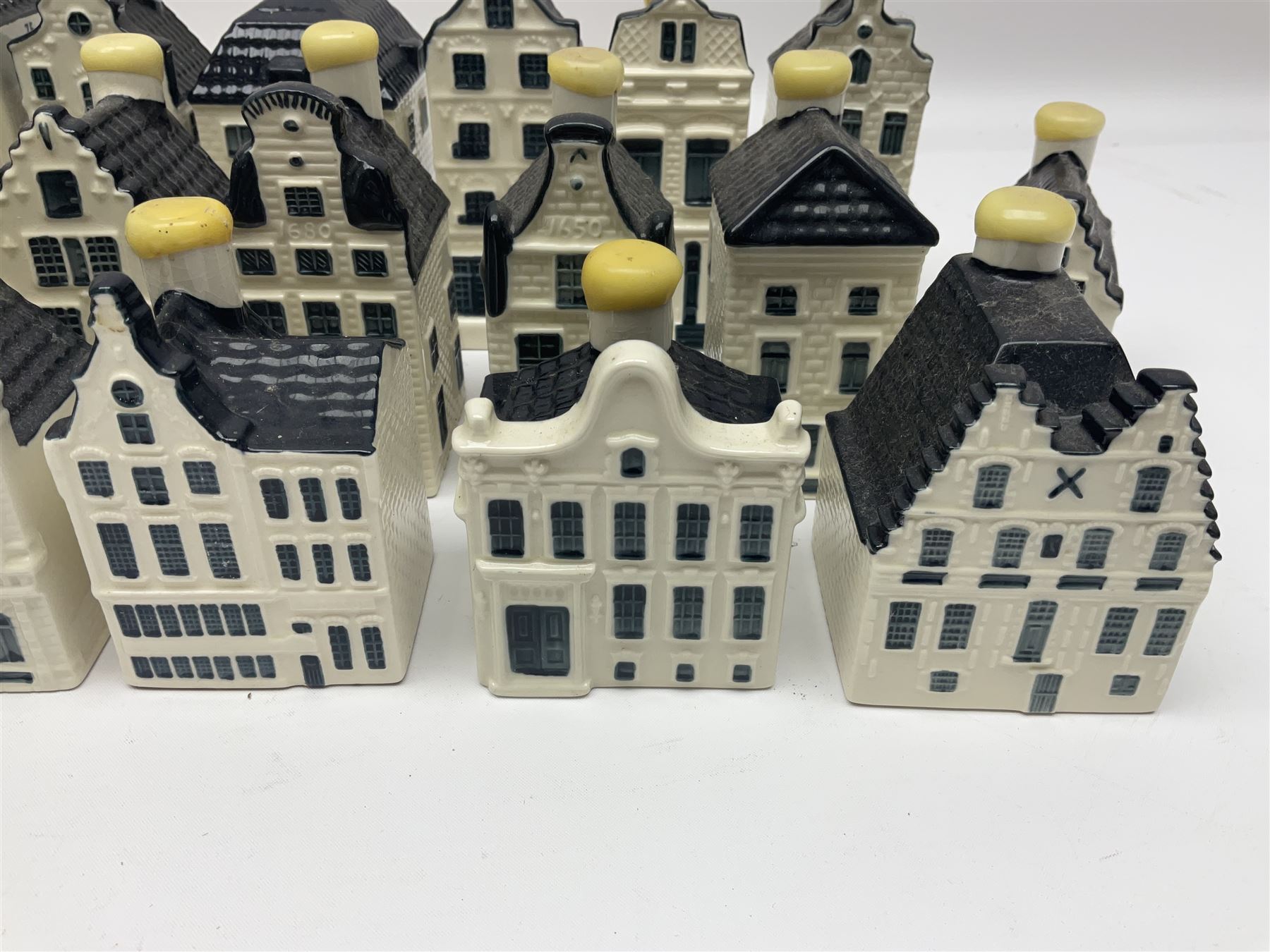 Twenty seven KLM Bols Blue Delft's decanters in the form of Dutch houses, some with contents