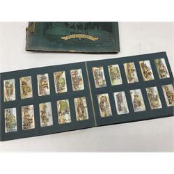 Three albums of cigarette cards including Wills Recruiting Posters, Military Motors and Allied Army Leaders, cricketers etc; another album containing a large quantity of laid-in cigarette cards; and an album of thirty-seven postcards of dogs by Mac (5)