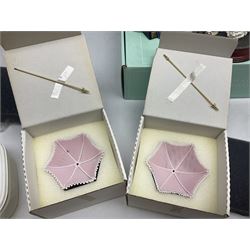 Seven Lladro flowers, comprising Japanese Camelia on base no 5181, Yellow Begonia on base no 5186, Miniature Begonia on base no 5188, Chrysanthemum on base no 5189, California Poppy no 5190.B, Miniature Begonia 5188.B and White Carnation no 5184.B, together with Lladro Spanish Joining pack with 17616 Winter Bell, Additional Lladro parasols and flowers etc 