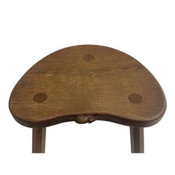 'Mouseman' oak three-legged stool, kidney shaped dished seat carved with mouse signature to edge, by Robert Thomas of Kilburn