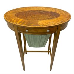 Edwardian inlaid satinwood work or sewing table, oval top with figured central inlay, fitted with a single drawer with bone handles, over a basket well covered with pale blue pleated fabric, raised on square tapering supports united by H-stretcher and ebony stringing single drawer with basket well