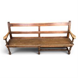 Early 20th century pine and oak bench seat, stained pine rail back frame with shaped oak arms