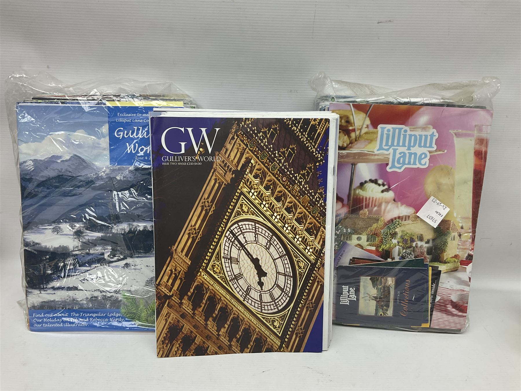 Twenty three Lilliput Lanes, including Village School, Lace's Shoe Shop, Cockles & Muscles, Scotland the Brave etc, together with The Leonardo Collection Paint Box Poppets and Gullivers World magazines 