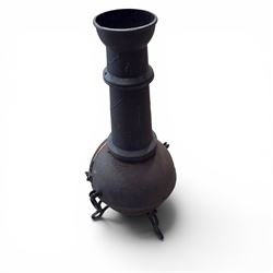 Cast iron garden chiminea, with mesh front spark guard, flue chimney on three splayed legs, finished in black.