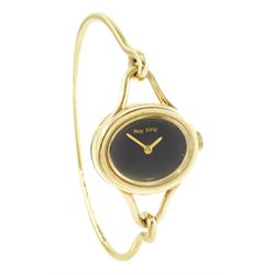 Roy King ladies 9ct gold manual wind wristwatch, black oval dial, on 9ct gold bangle, London 1978