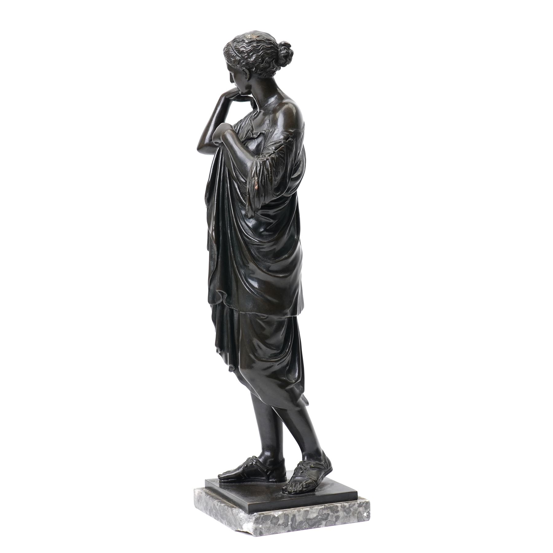 After the Antique - Grand Tour patinated bronze figure of a Vestal Virgin, the maiden standing in contrapposto, draped in classical robes and pinning her chiton at the shoulder and chest, on a square marble base stamped to rear, circa 1900, W15cm H47cm