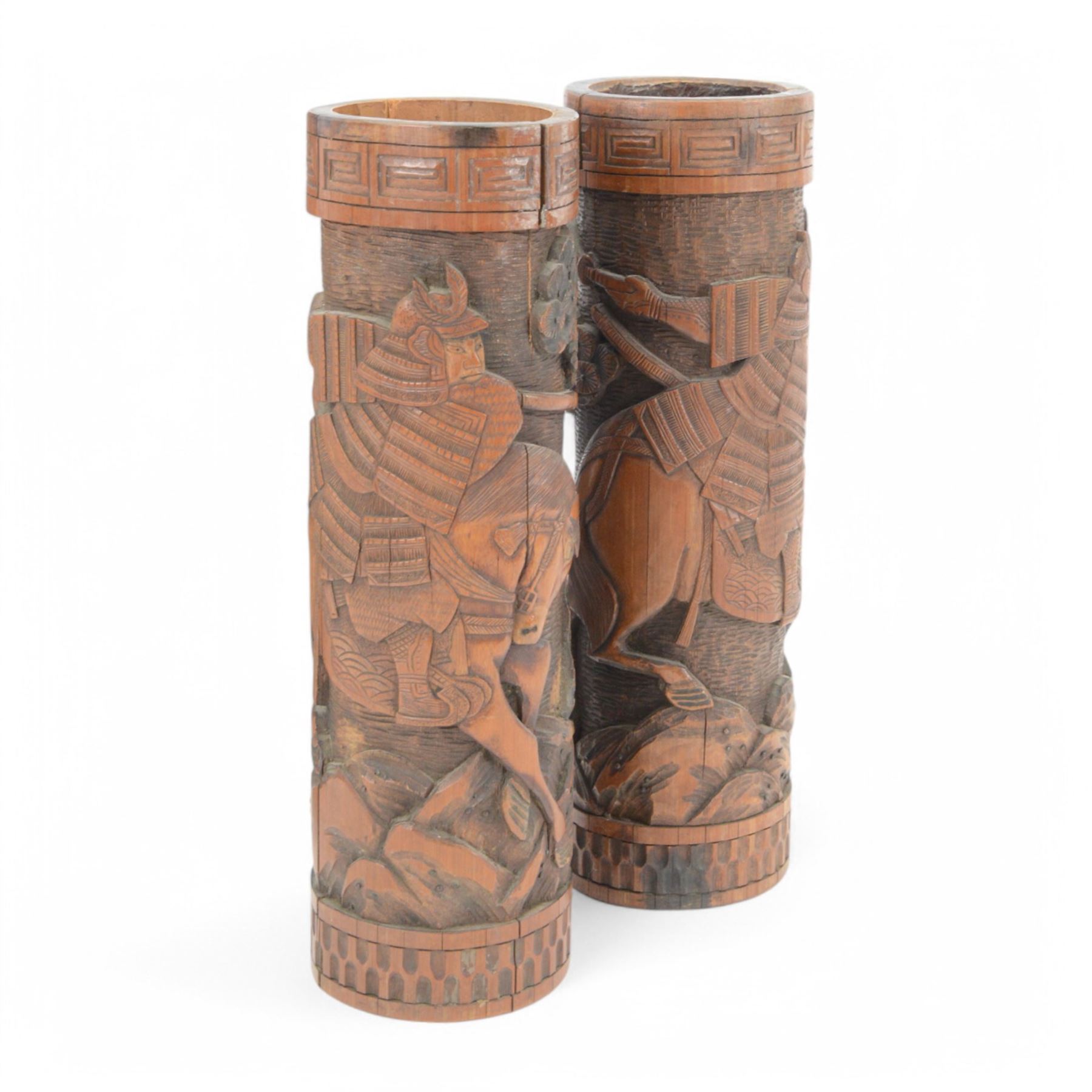 Pair of Japanese carved bamboo brush pots, each depicting a Samurai on horseback, together with an Indian wooden carved panel depicting the Hindu God Krishna, tallest H46cm