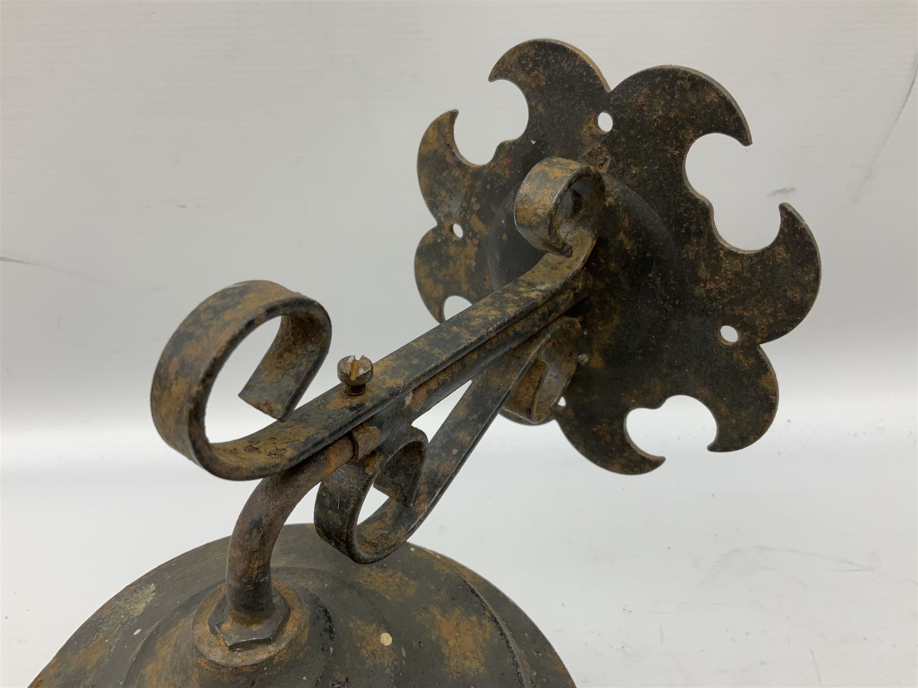 Wrought iron wall lantern with patterned glass shade of tapering cylindrical form, H29cm