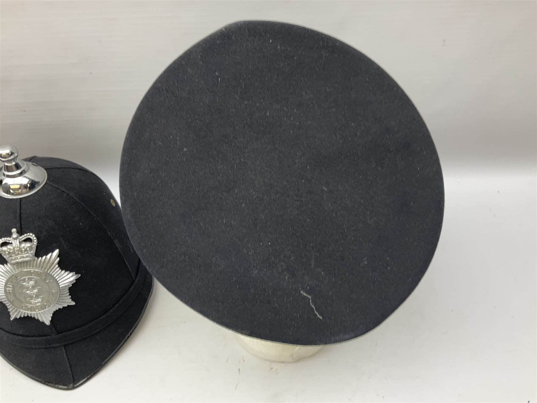 Hull City Police - helmet with king's crown night plate; two further ball-top helmets with Queen's crown plates; and a peaked cap (4)