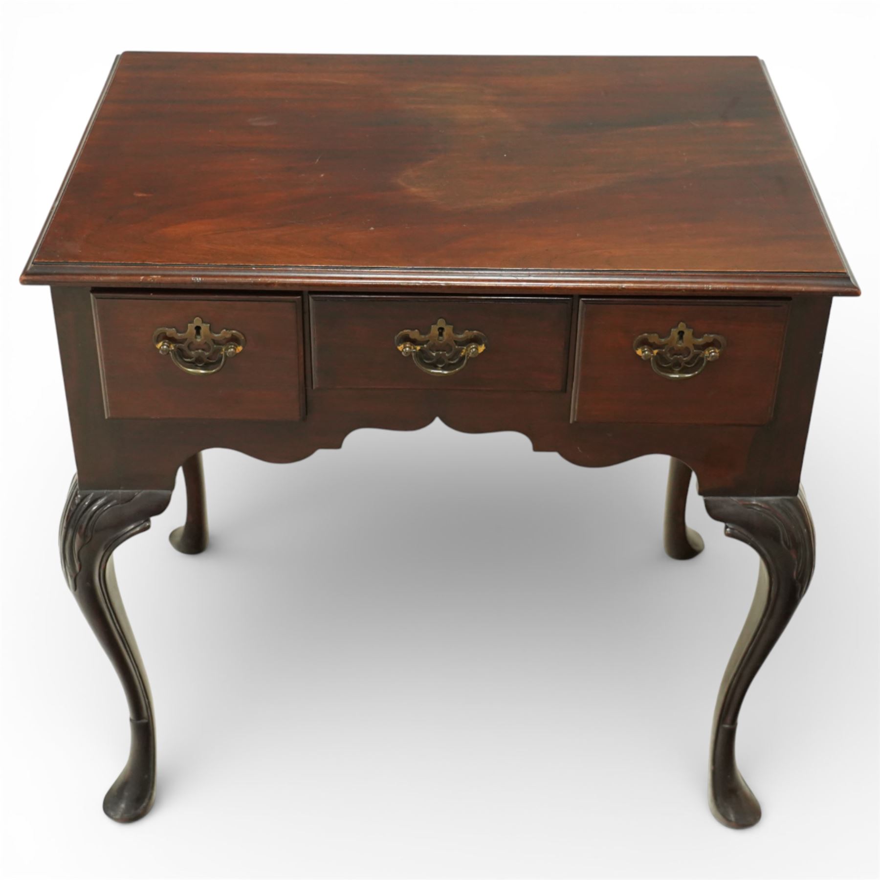 Early 20th century Irish mahogany lowboy, rectangular moulded top over three frieze drawers fitted with brass swan neck handles and escutcheons, shaped apron, raised on cabriole supports terminating in pad feet