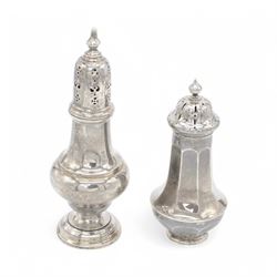 Two early 20th century silver sugar casters, the first an Edwardian example of faceted urn form, hallmarked Sibray, Hall & Co Ltd, London 1910, the second a 1920s example of typical urn form, upon a stepped circular filled base, hallmarked William Neale & Son Ltd, Birmingham 1925, tallest H20cm