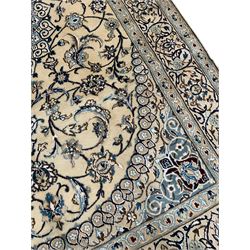 Persian Kashan ivory ground rug, central medallion surrounded by scrolling leafy branches and stylised flowerhead motifs, scrolling border decorated with further stylised plant motifs