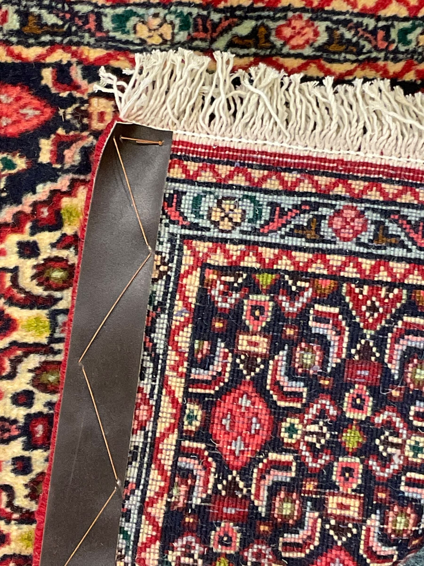 North West Persian Senneh indigo and crimson ground runner, the Herati decorated field with five interconnected lozenges, triple band border with repeating flower head motifs 