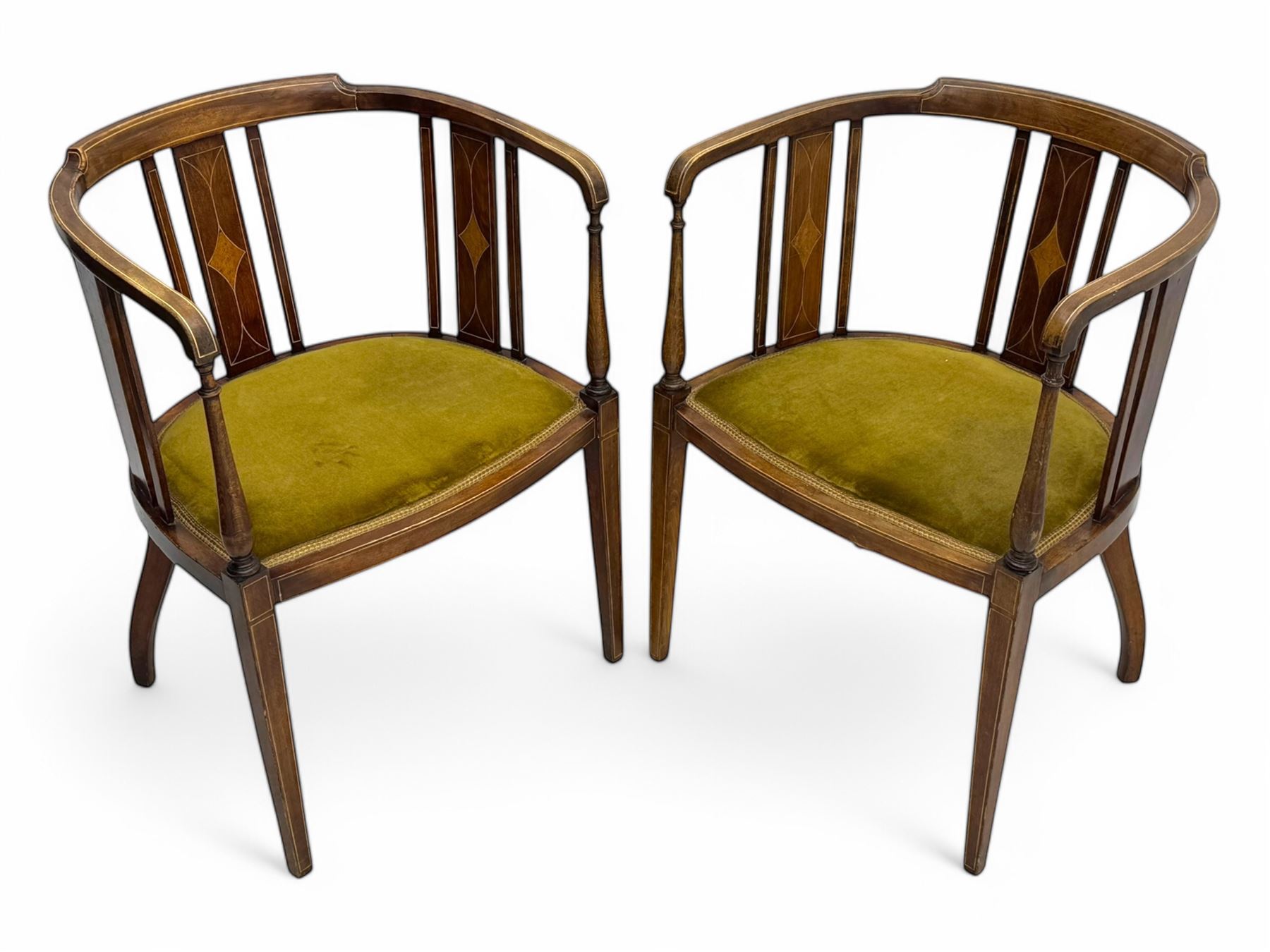 Pair of early 20th century Edwardian inlaid mahogany elbow chairs, shaped top rails with central diamond motif and line inlays, flanked by turned uprights, green velvet seats, on square tapered legs