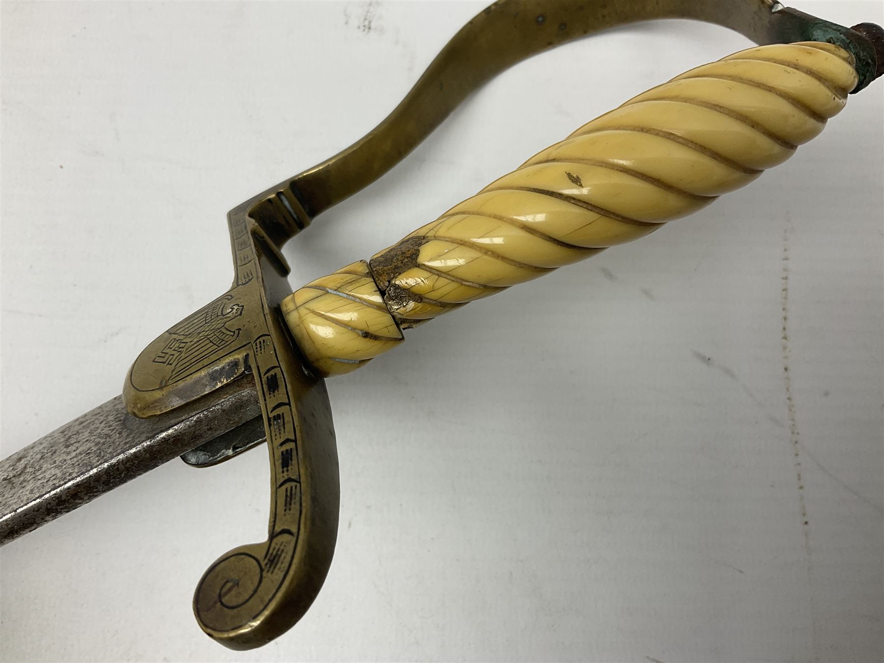 1900-1918 German Imperial NCO sabre with WW2 modifications of Wehrmacht insignia to the langet, 79cm slightly curving fullered blade and brass hilt, the knucklebow chased with oak leaves and acorns L90.5cm overall
This item has been registered for sale under Section 10 of the APHA Ivory Act 