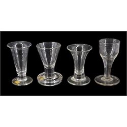 18th century firing glass, the funnel bowl upon a flanged firing foot, H9.5cm, together with three further 18th/early 19th century drinking glasses with firing type feet
