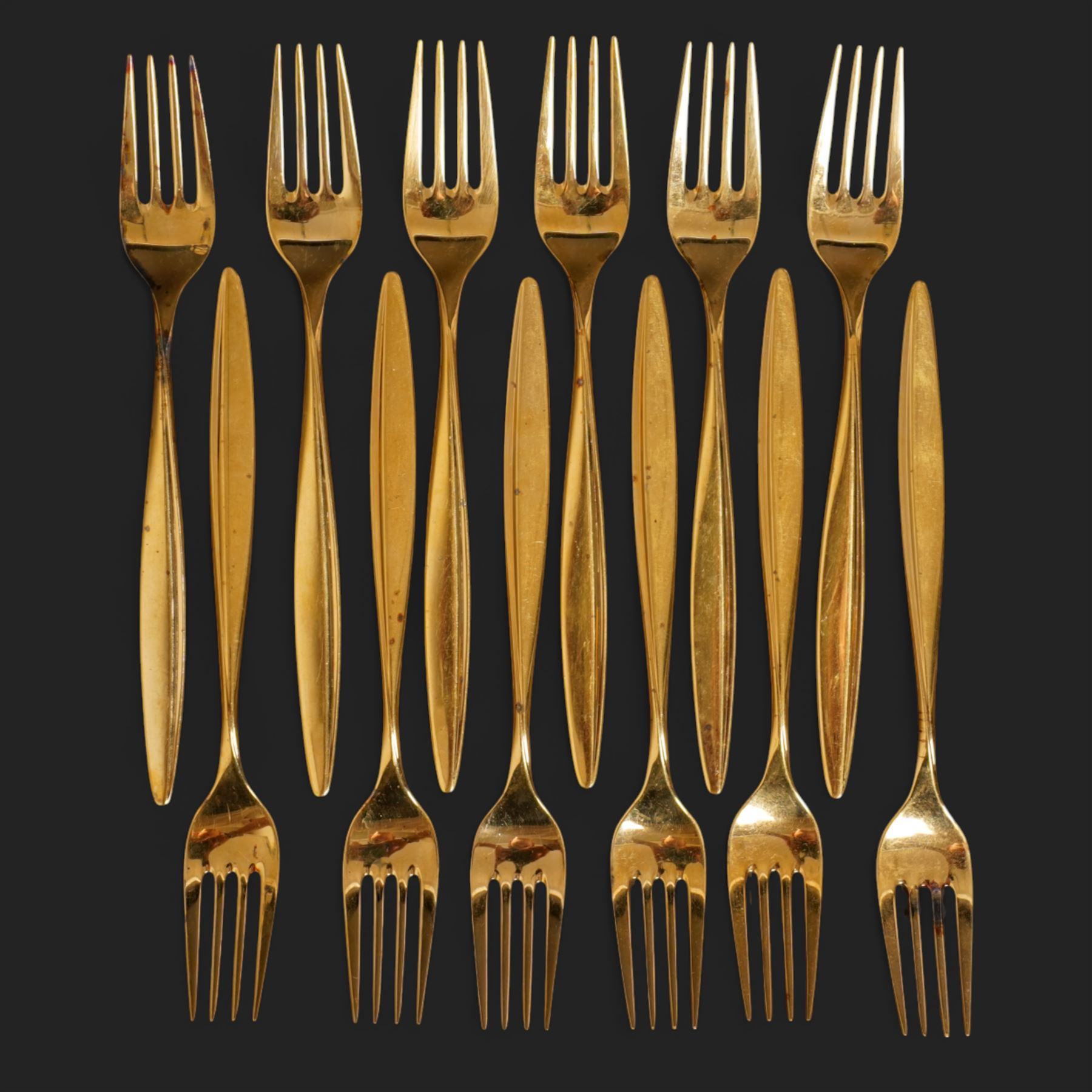 Extensive suite of WMF 800 silver gilt cutlery, for twelve covers, comprising twelve table knives and forks, fish knives and forks, dessert forks, table spoons, dessert spoons, teaspoons, eleven dessert forks and six serving spoons, with crescent moon and crown WMF hallmarks