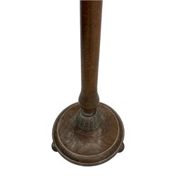 Early 20th century oak standard lamp base, of baluster form with fluted acorn finial and carved foliate decoration to the base, raised on circular plinth with bun feet