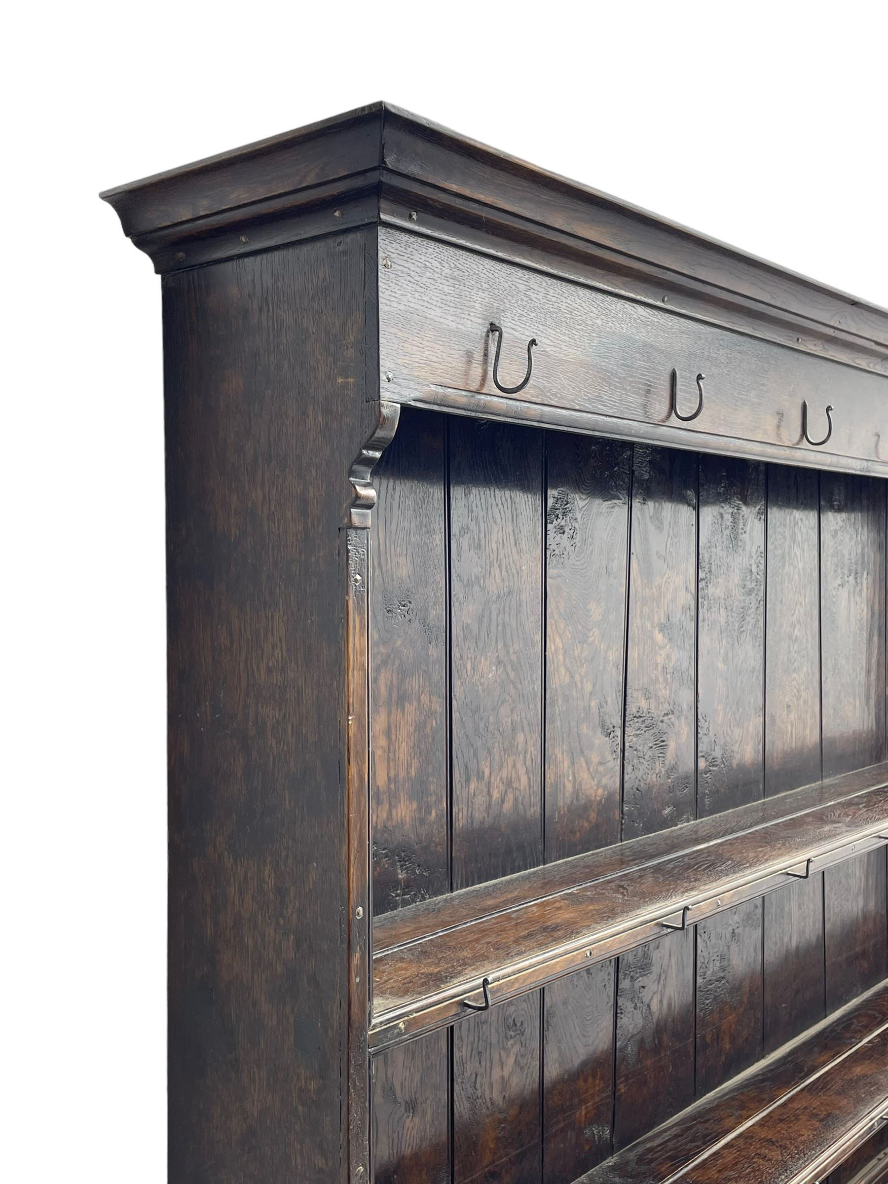 Bylaws of Leominster - 18th century design figured oak dog kennel dresser, the raised plate rack with projecting cornice over hooks and three tiers, moulded rectangular top over three drawers and two panelled cupboards, moulded frame and panelled sides, on stile supports