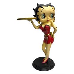 Contemporary Betty Boop waitress figure, modelled standing with one hand holding a circular tray, dressed in a red dress with gold accents, on a black circular base