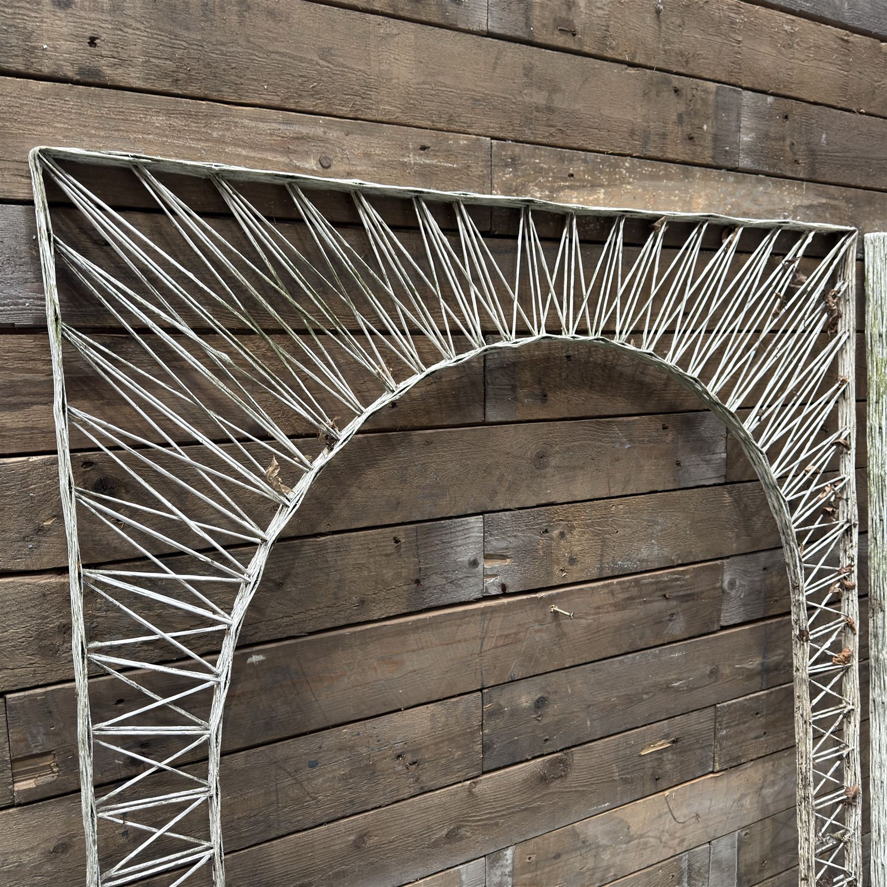Four early 20th century French painted wicker garden trellis or dividers, rectangular form with internal arches