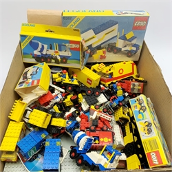 Lego - constructed models including 1239 Racers, 6367 Articulated lorry, 2 x diggers, helicopter, cement mixer, tow truck, rally cars, dumper trucks, crane, petrol tanker, garbage lorry, postal van, motorway vans, seventeen square road bases and quantity of loose sections, various instruction leaflets and 1980s catalogues, empty boxes etc