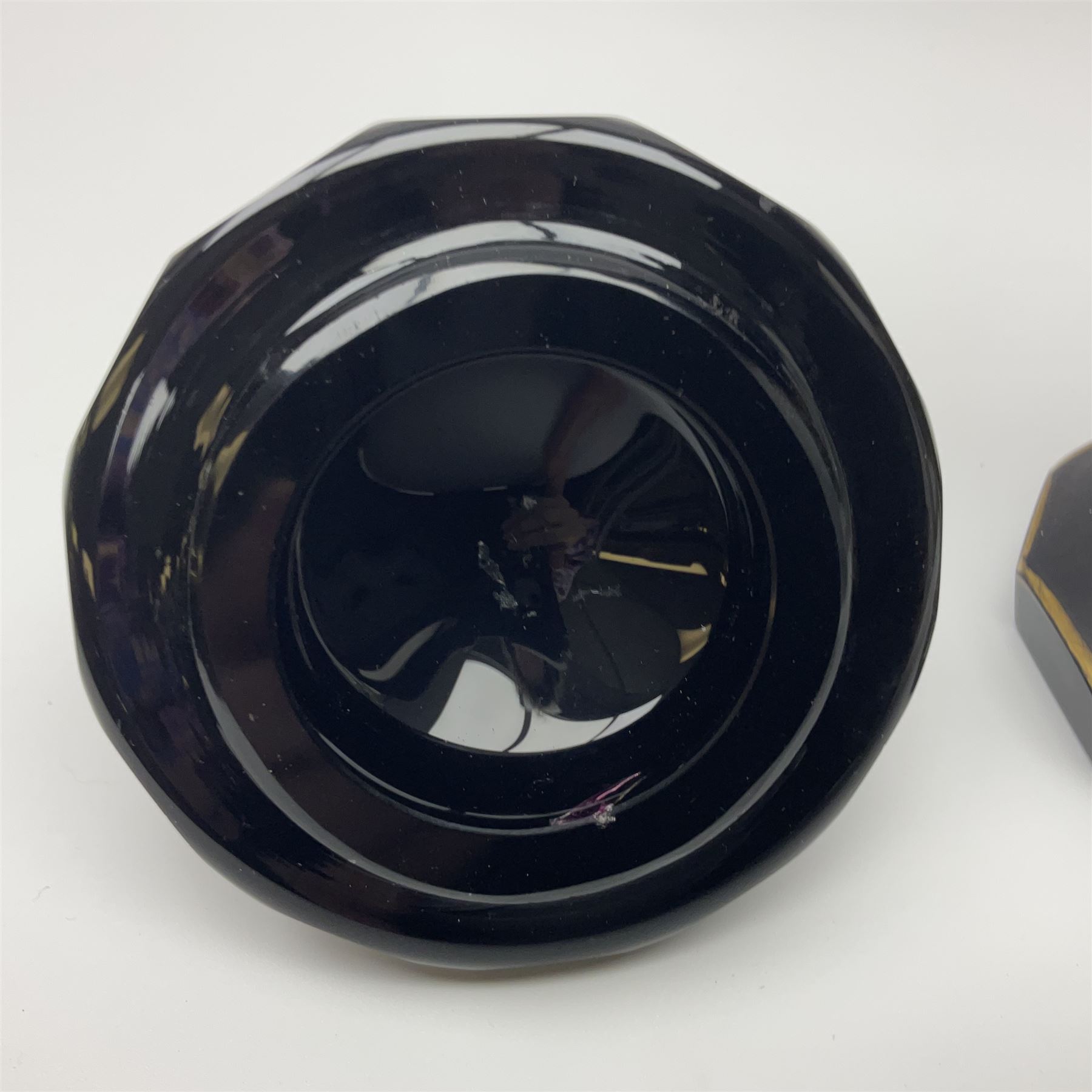 19th Century Bohemian amethyst glass lidded goblet, the bowl of faceted form, gilded with three children in period dress playing games, upon a knopped stem and conforming faceted foot, together with an art nouveau green glass goblet, with gilded rim, upon clear trumpet stem, and a hand blown wine glass, transfer printed with birds and three figures in period dress, tallest H29cm