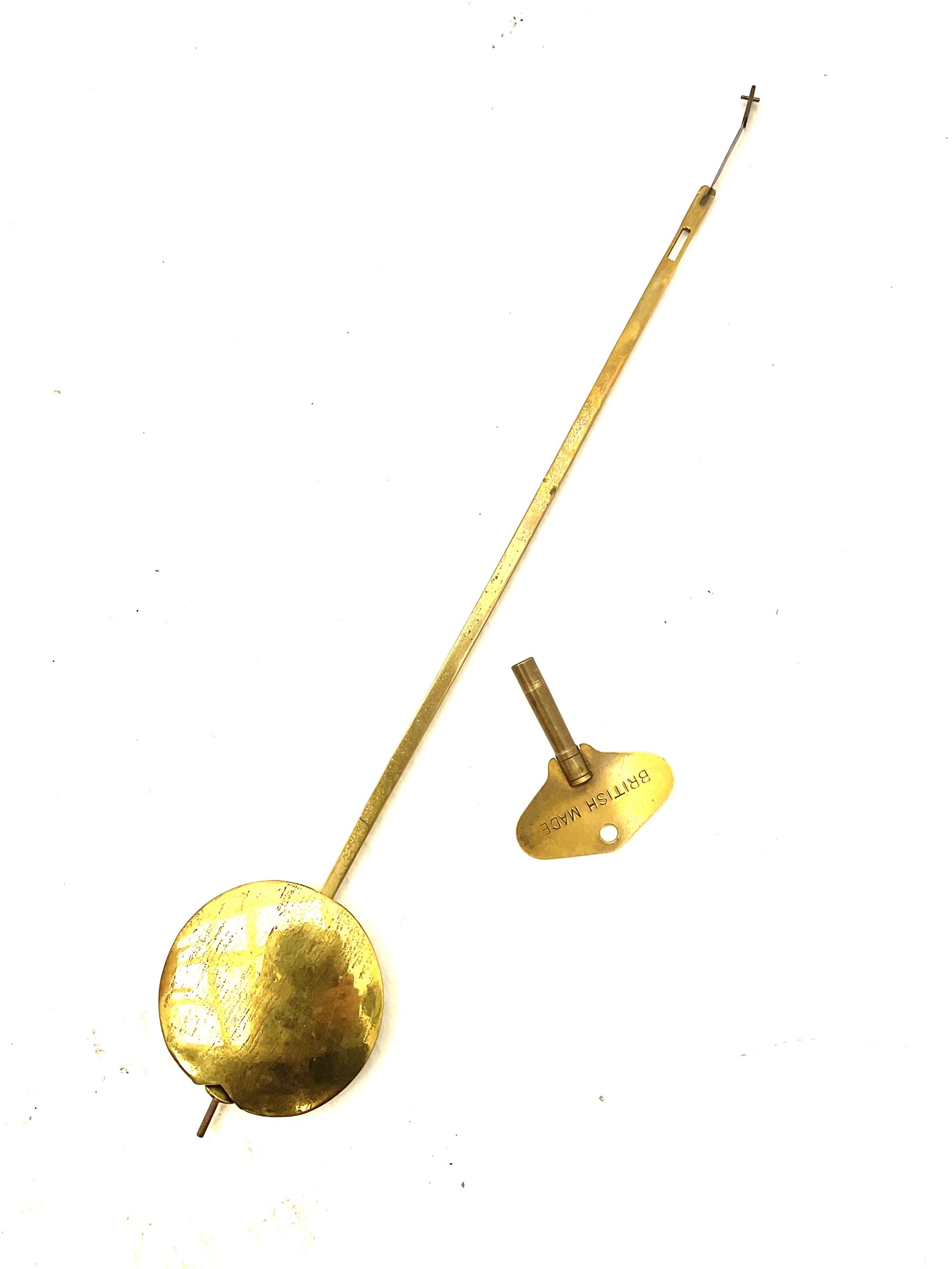 Mid-19th century mahogany veneered eight-day four-pillar single fusee drop dial wall clock with an octagonal dial surround and scroll brass inlay, circular painted steel dial with roman numerals and minute track, matching trefoil steel hands, brass bezel with a flat glass, curved trunk with brass inlaid circles and stringing around the glass pendulum aperture with a brass slip, carved ear pieces in the form of flowers and leaves, with pendulum adjustment door and movement door. With Pendulum & Key