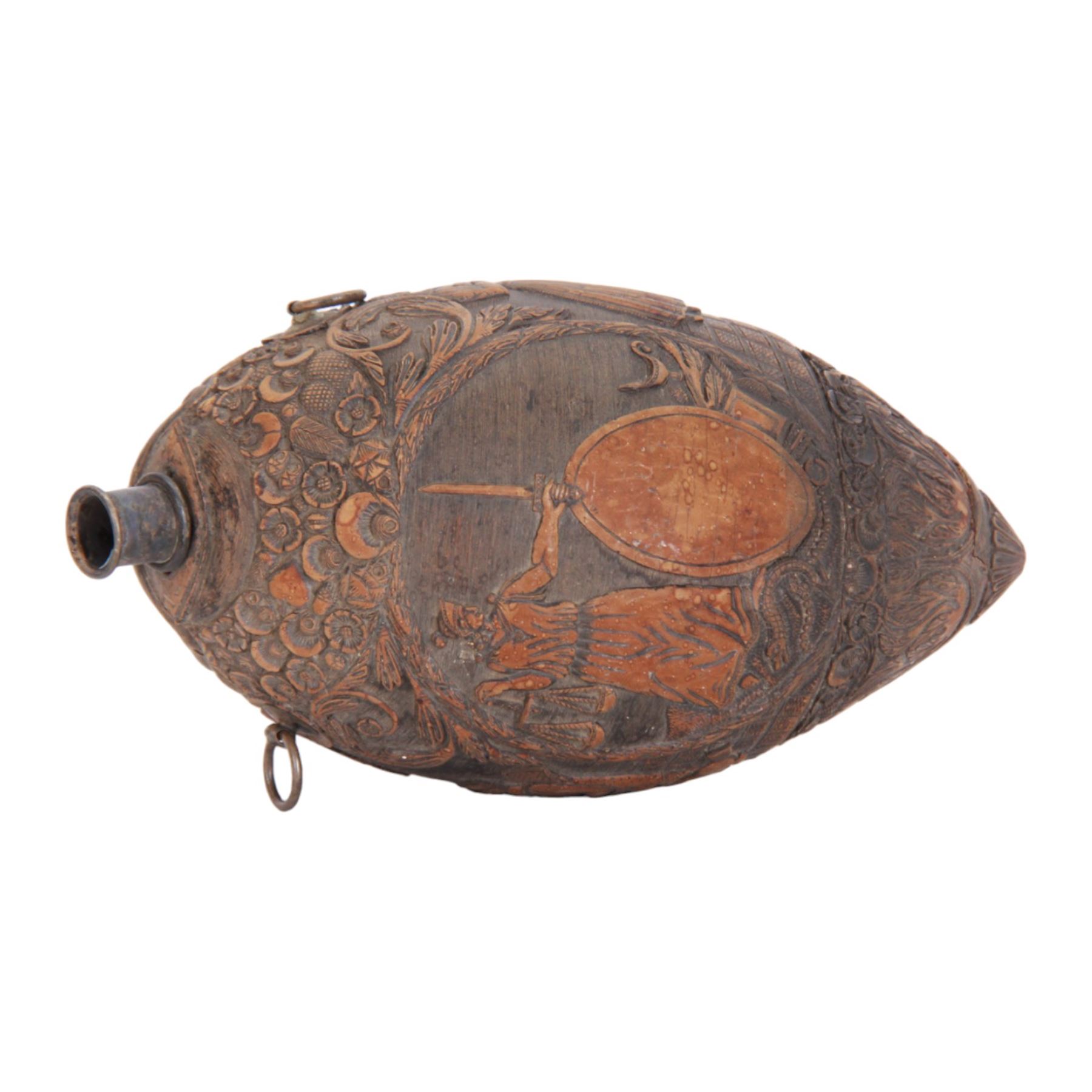 Early 19th century carved coconut 'bugbear' flask, carved with circular panel of Justice stood by a vacant oval shield, holding scales and sword aloft, and stood upon a serpent, and a vignette carved with figures in merriment, drinking and playing music, with profusely carved foliate detail to the rest of the body, the top carved with typical grotesque face with inset glass eyes, and metal nozzle mouthpiece, including mouthpiece L17.5cm 

