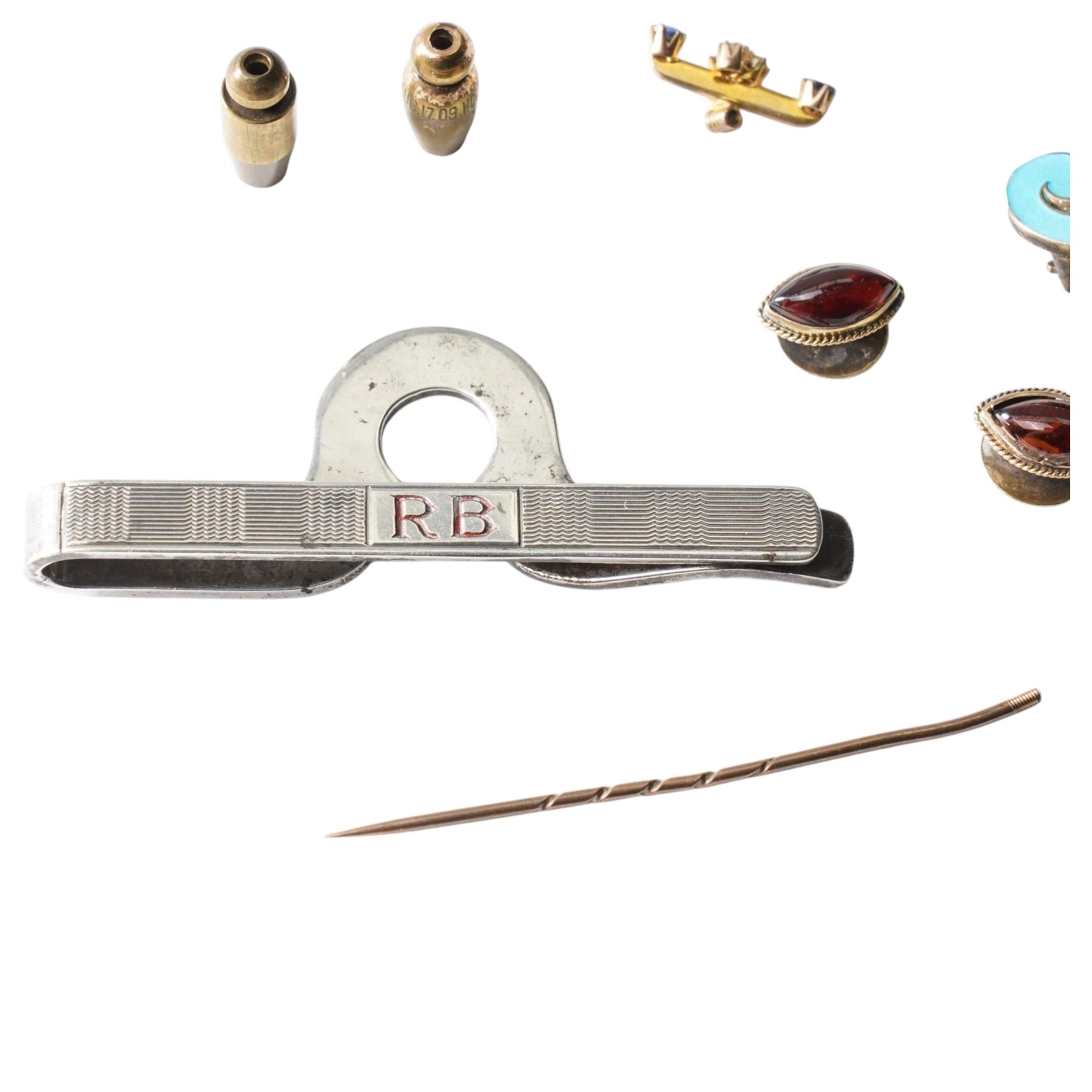 Pair of silver and enamel J clip on earrings, pair of gold cabochon garnet dress studs, silver money clip, gold dress stud and three backs, diamond set stick pin head etc 