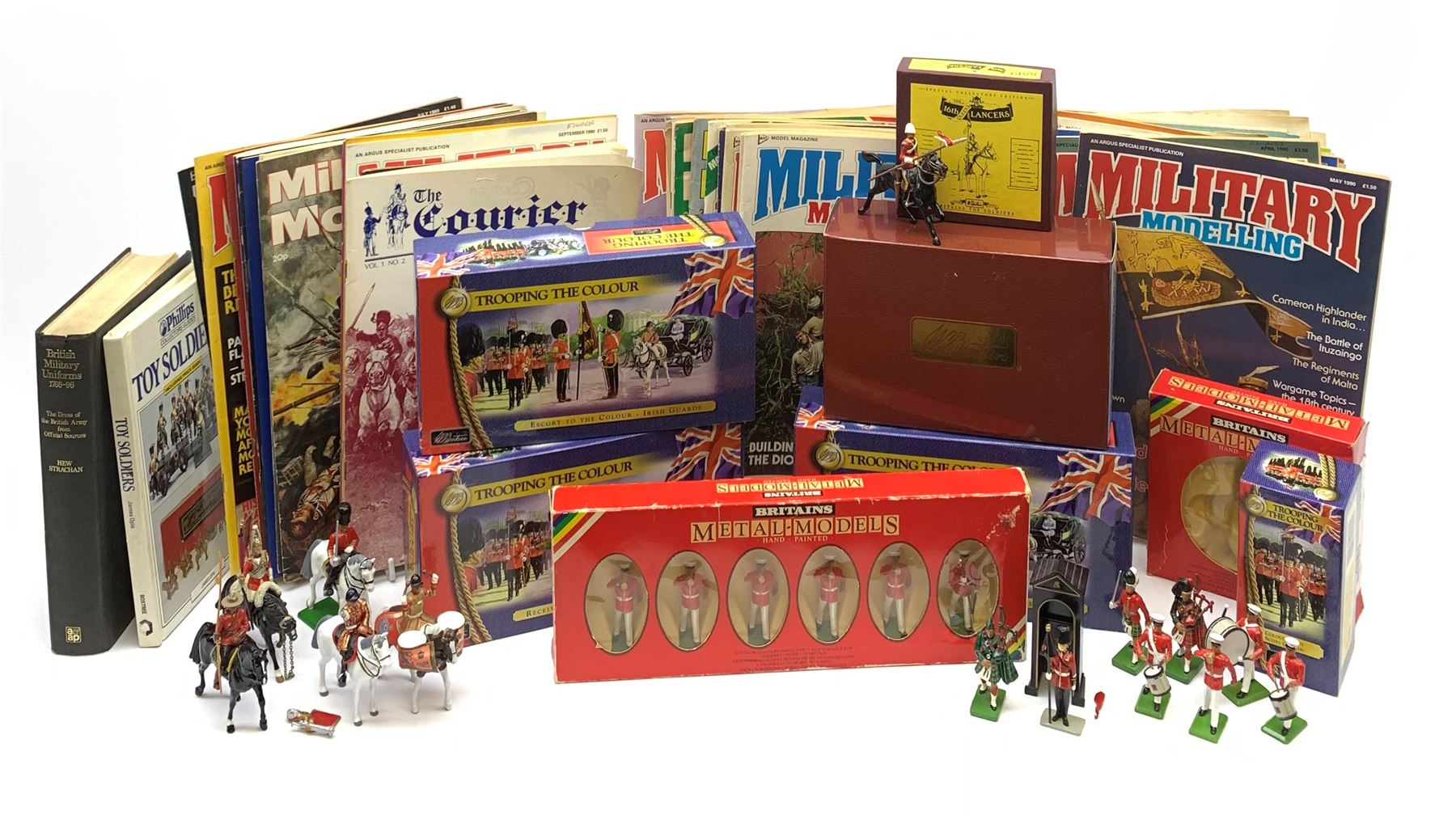 Britains - four Trooping the Colour sets 40109, 40110, 40112 & 40113; The Duke of Wellington with 95th Rifleman No.41160; and 8819 Lancer figure from the 16th Queens Lancers; all mint and boxed; together with a quantity of unboxed figures etc; and collection of books and magazines on model soldiers