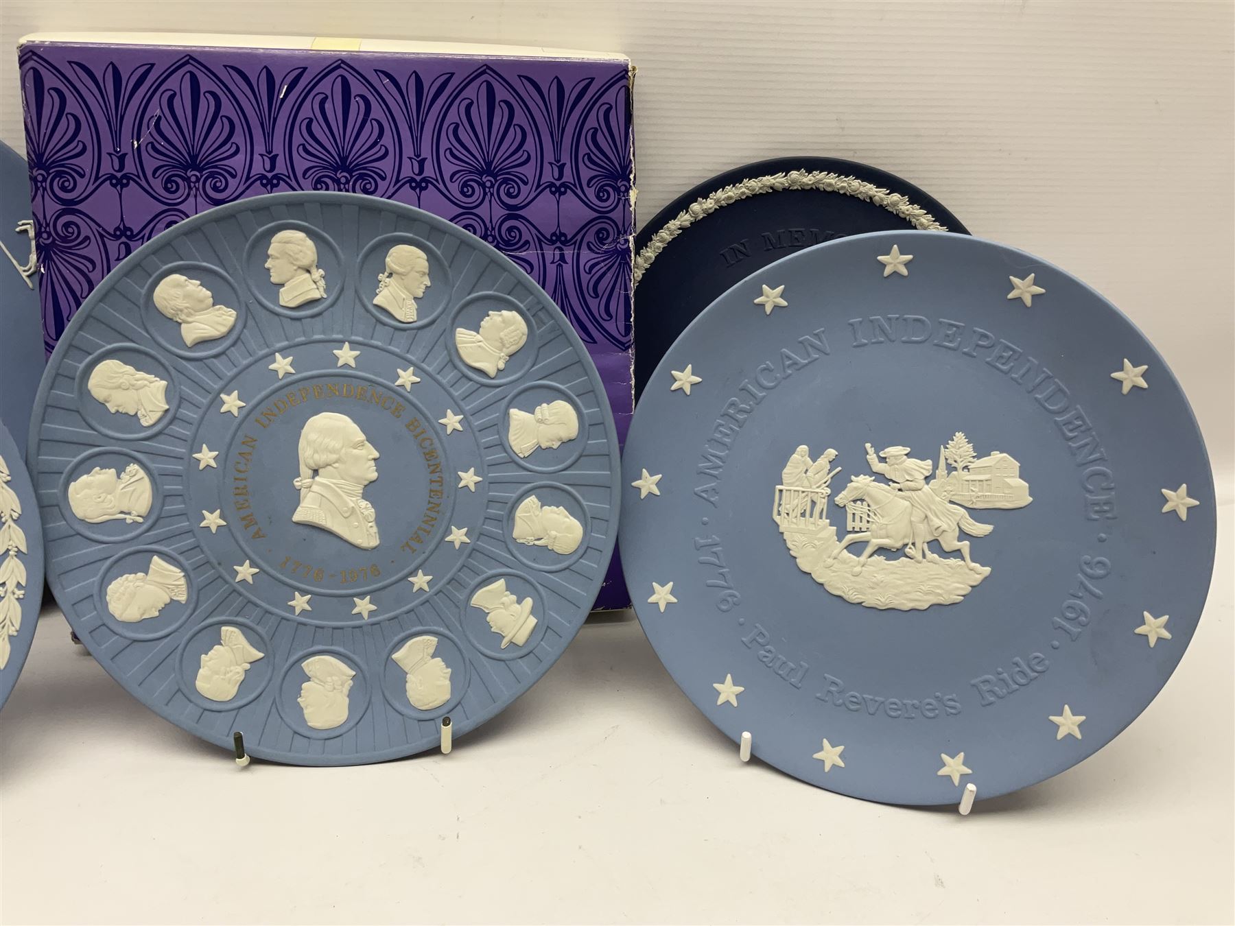 Collection of Wedgwood Jasperware, to include black Eisenhower Bust, two black basalt paperweights, one depicting an eagle and one depicting Julius Caesar, a blue Zodiac plate, Man on the Moon commemorative plate, American Independence Bicentennial plate and Royal commemorative ware, etc, all with impressed marks beneath, some with boxes