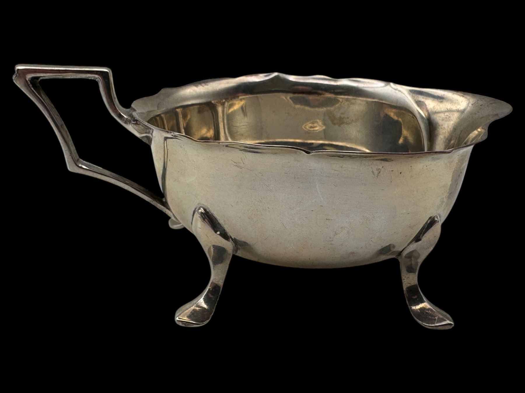 Silver cream jug and two napkin rings, all hallmarked 