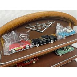 Franklin Mint 'The Classic Cars of the Fifties' collection with display rack, eleven (ex.12) die-cast models and folder of paperwork; another wall mounting display cabinet containing fifteen die-cast models; and an unused boxed Master Tools model display case