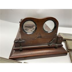 Victorian mahogany table top stereograph viewer, the top section with folding stereoscope and sliding image holder with fret work top, together with glass stereoscopic views