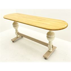 Painted pine kitchen table, painted turned and carved supports joined with stretcher, raised on castors 