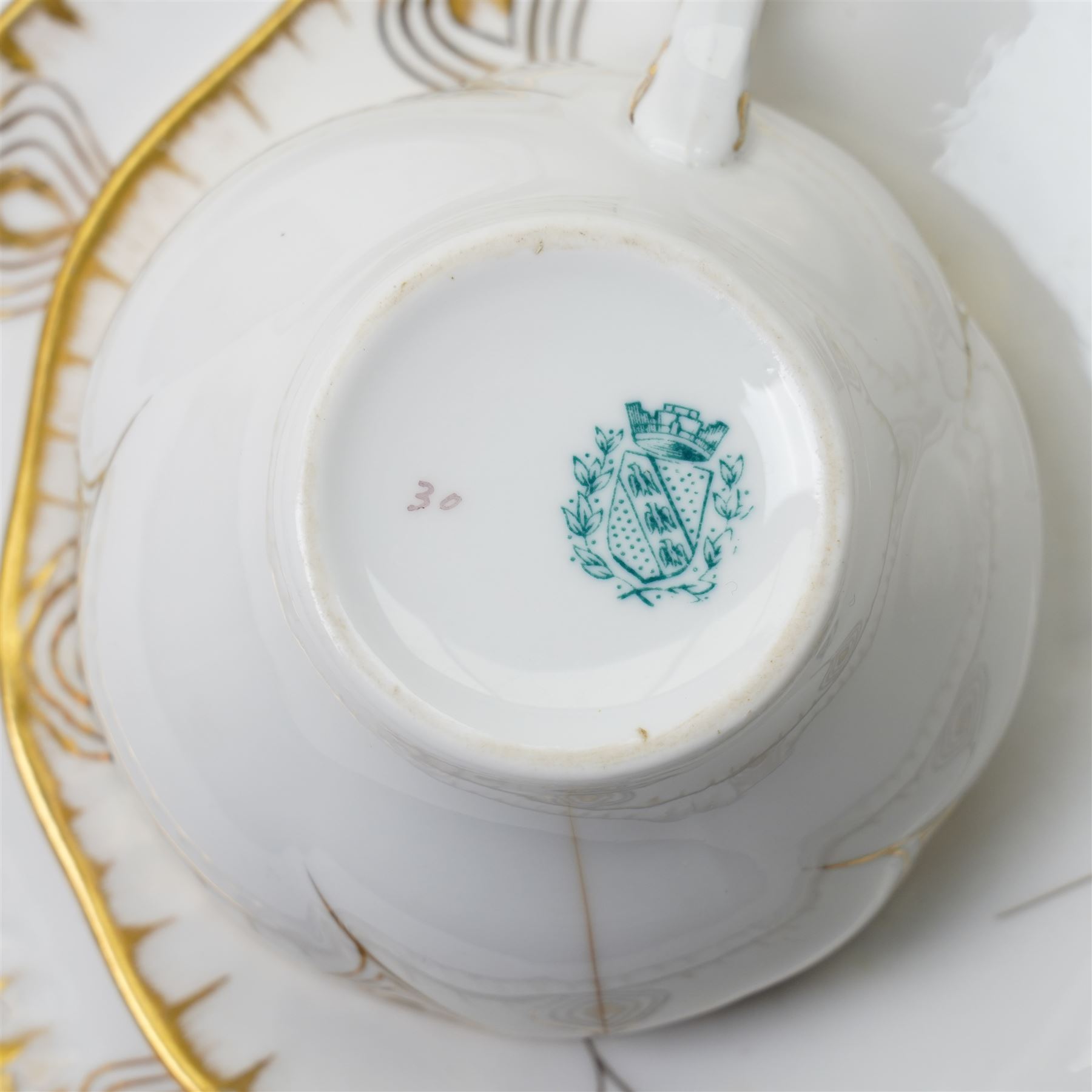Early 20th century Sarreguemines tea wares, decorated with peacock feathers in gilt, comprising six teacups, eight saucers and eight side plates