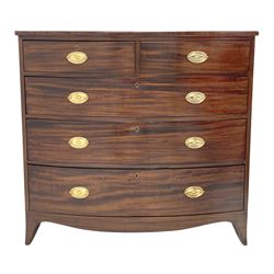 Early 19th century figured mahogany bow front chest, two short and three long drawers, shaped apron with splayed bracket feet, oval brass plate handles