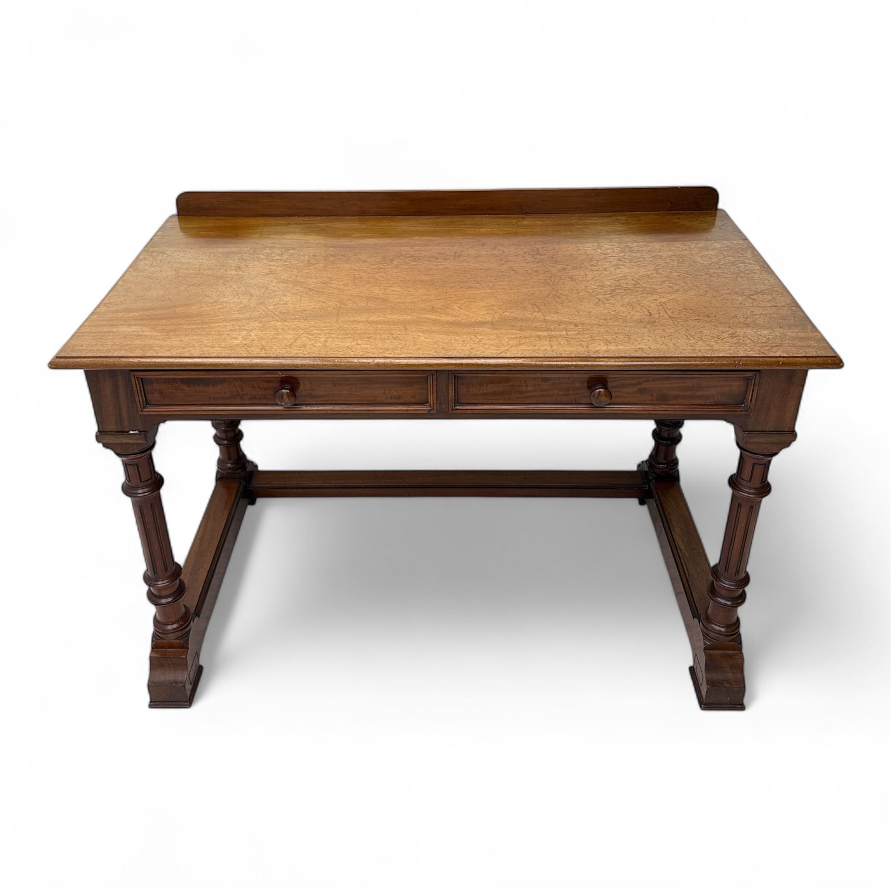 Late Victorian mahogany side table in the style of Gillows of Lancaster, mahogany rectangular top above two frieze drawers, the top edge of the right drawer stamped 'Gillow' and 'L486' with knob handles supported on turned stop and fluted legs with stretcher base on recessed castors

Provenance: The Davies-Cooke Collection from Gwysaney Hall, North Wales  