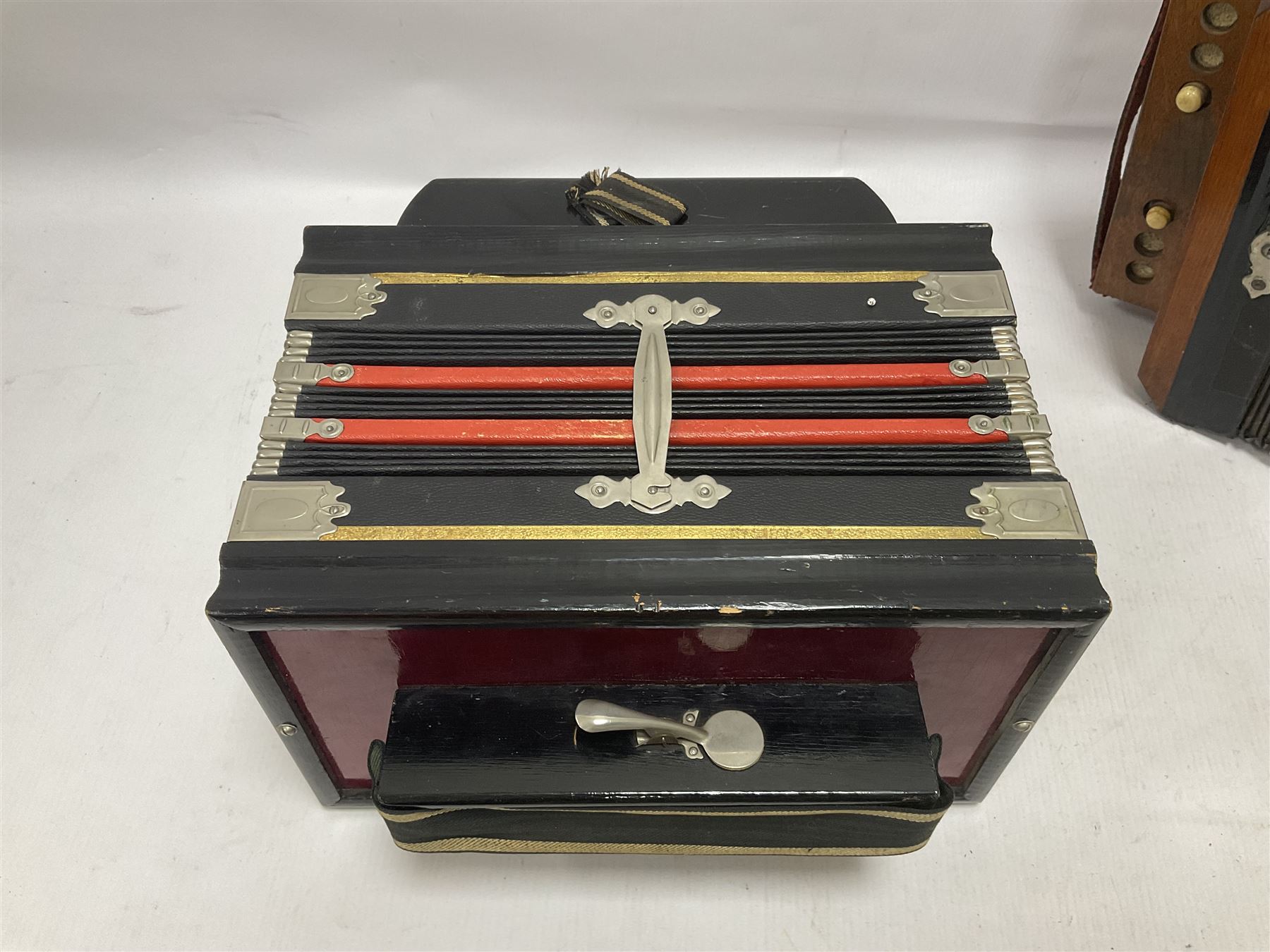Three European concertinas, comprising Viceroy German concertina with 21 keys, hexagon wooden frame and 8 fold bellows
Oak framed concertina with 12 keys and 8 fold bellows
Commander concertina with 12 keys and 12 fold bellows
With tutor