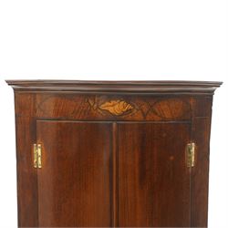 Georgian inlaid walnut cylindrical corner cupboard, projecting cornice over a banded frieze with inlaid shell motif, enclosing three shelves with two spice drawers fitted to base