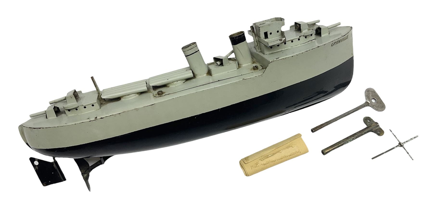 Pre-war Sutcliffe Grenville tinplate clockwork Battleship, with black and grey hull, grey deck and upper decks, propeller and rudder, length 32cm; with manuscript biographical details and two keys, unboxed