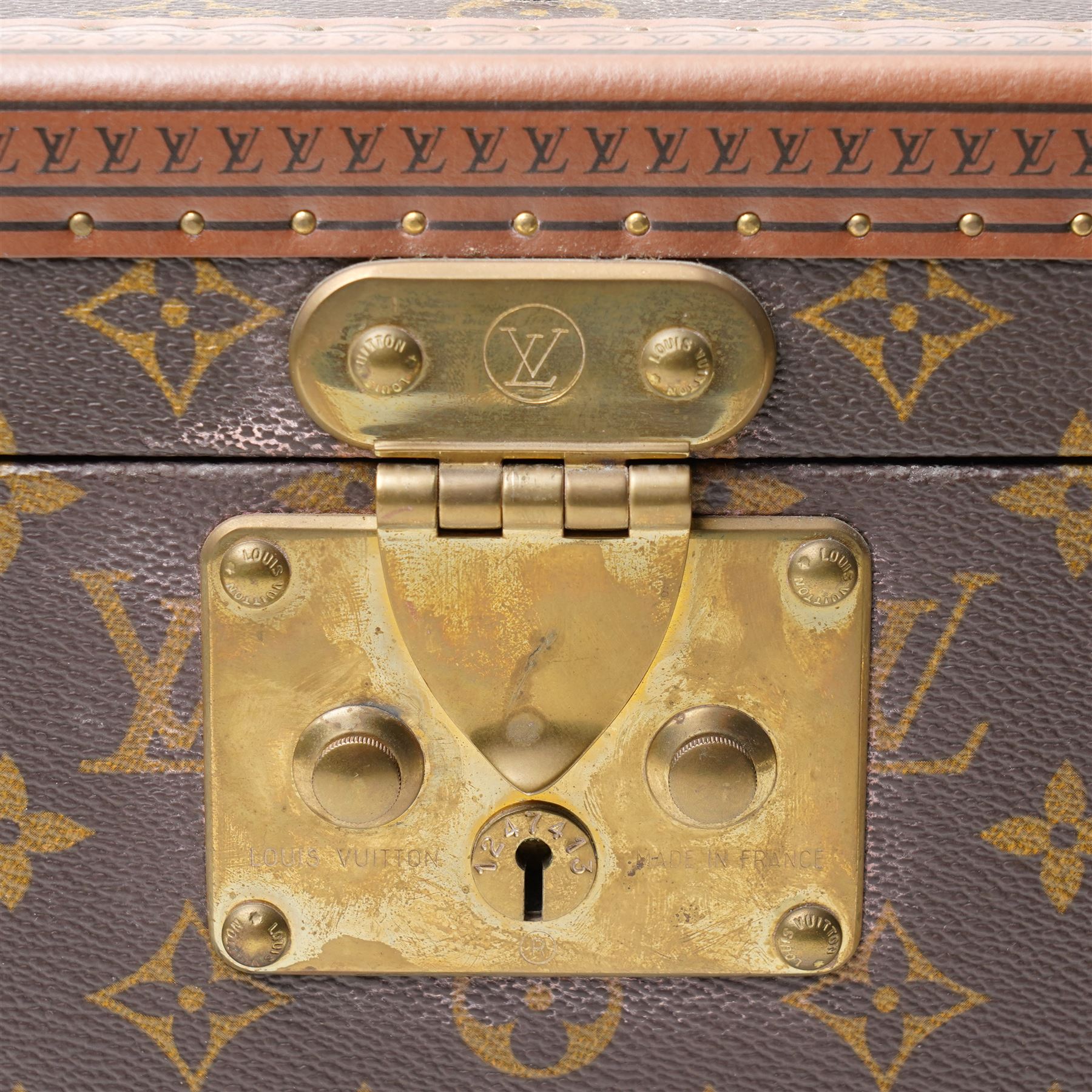 Late-20th century Louis Vuitton monogram Boîte Flacons vanity coffret, monogram canvas with lozine trim and brass mounts, single front brass lock stamped Louis Vuitton with key code 1247413, the interior fitted with leather flacon retaining loops and lift-out lidded tray with leather handle, label to interior printed Louis Vuitton Paris serial number 1045768, together with two keys stamped with matching serial numbers to the lock and luggage tag, circa late 1990s-early 2000s