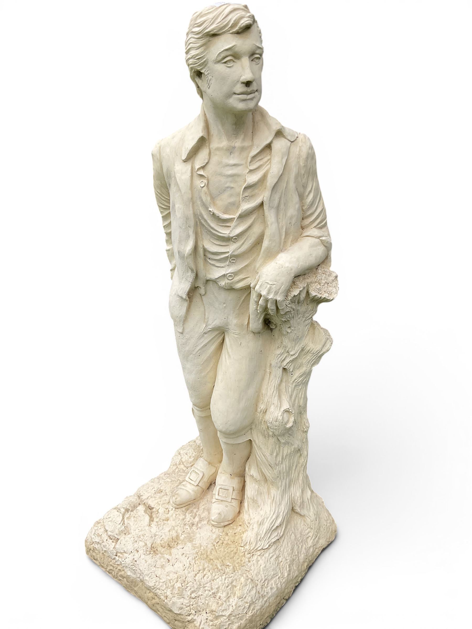 Cast stone garden statue of a Regency style gentleman, modelled with a side parting and unbuttoned shirt with breeches, on a naturalistic rectangular base