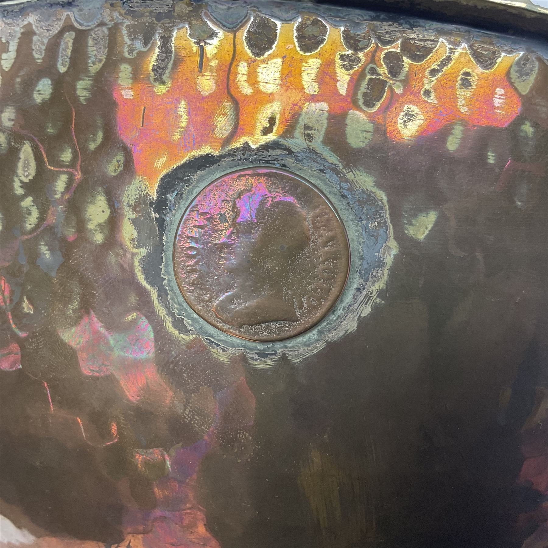 Copper pedestal punch bowl, with planished decoration with twin lion mask and ring handles and applied coins, H18cm