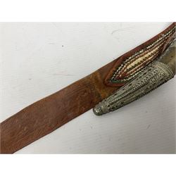 Saudi Arabian khanjar dagger with 29.5cm curving double edged  steel blade; white metal and copper mounted horn grip; in white metal mounted brass and leather scabbard incorporating embroidered leather wearing strap
