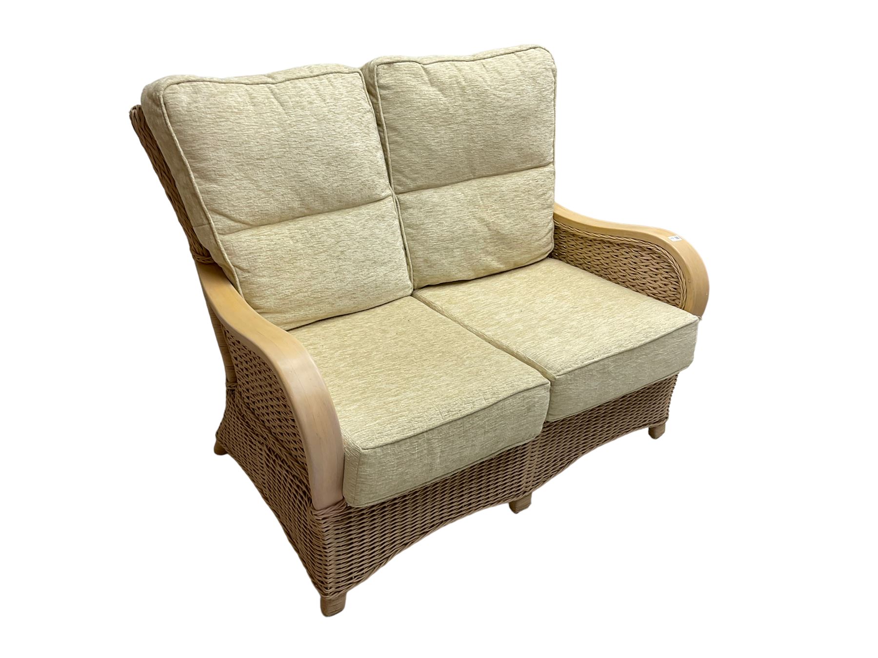 Contemporary rattan conservatory suite - two seat sofa with wicker frame and loose cushions upholstered in textured champagne fabric (W125cm H98cm); pair of matching armchairs (W72cm H98cm); rectangular glass-topped coffee table with rattan frame and undertier (W85cm D60cm H47cm); and matching square side table (W53cm H55cm)