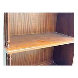 Mid-20th century mahogany open bookshelf, the rectangular top with a brass balustrade gallery, over three shelves each supported by turned column uprights, on shaped apron base